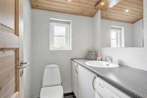 a bathroom with a sink and a toilet and a mirror at 30859-Ulfborg-Bellisvej-432 in Ulfborg +16 photos