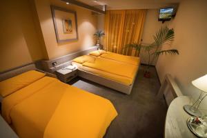 Postel nebo postele na pokoji v ubytování Hotel Marzia