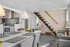 a kitchen and living room with a spiral staircase at 70029-Ulfborg-Vesterhavsgade-6 in Ulfborg +15 photos