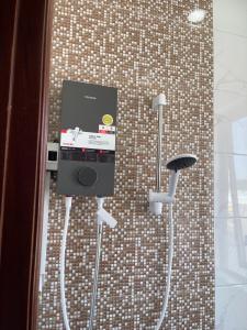 a device on a wall in a bathroom at Tôm Tít Homestay in Phú Quốc +31 photos
