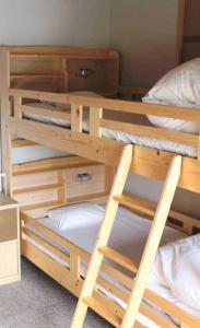 a bedroom with two bunk beds with white pillows at ゲストハウスkaminn in Yoshino