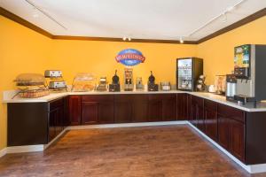 a kitchen with yellow walls and a counter with refrigerators at Baymont by Wyndham Modesto Salida in Modesto
