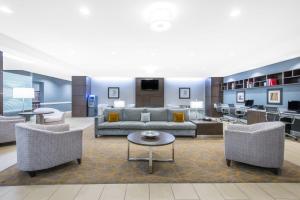 a living room with a couch and chairs and a table at Wingate by Wyndham Niagara Falls in Niagara Falls