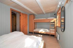 a bedroom with a bed and bunk beds in it at 10019-Ulfborg-Gaffelbjergvej-18 in Ulfborg