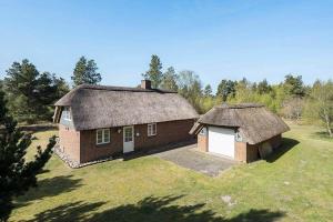 an old house with a thatched roof on a field at 10019-Ulfborg-Gaffelbjergvej-18 in Ulfborg