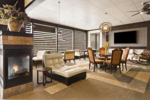 a living room with a fireplace and a dining room at Days Inn by Wyndham Vermilion in Vermilion