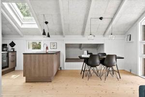 a kitchen with a table and chairs in a room at 30134-Ulfborg-Klovervej-475 in Ulfborg +21 photos