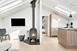 a living room with a fireplace in the middle of the room at 30134-Ulfborg-Klovervej-475 in Ulfborg