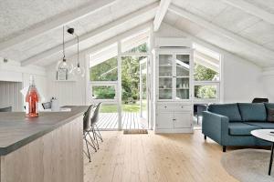 a kitchen and living room with a table and chairs at 30134-Ulfborg-Klovervej-475 in Ulfborg