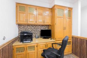 a room with a desk with a computer and a chair at Super 8 by Wyndham Bedford in Bedford