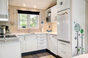 a kitchen with white cabinets and a white refrigerator at 30121-Ulfborg-Klovervej-474 in Ulfborg +14 photos