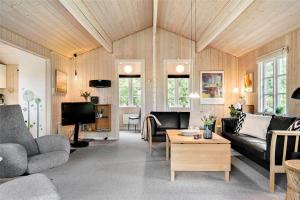 a living room with a couch and a table at 30121-Ulfborg-Klovervej-474 in Ulfborg