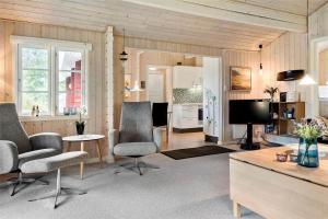 a living room with two chairs and a television at 30121-Ulfborg-Klovervej-474 in Ulfborg