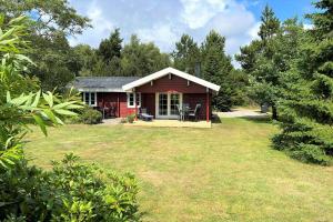 a small red house with a large yard at 30121-Ulfborg-Klovervej-474 in Ulfborg
