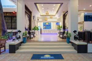a lobby of a store with stairs and potted plants at Days Inn by Wyndham Patong Beach in Patong Beach
