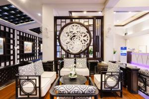 a lobby with white furniture and a large window at Days Inn by Wyndham Patong Beach in Patong Beach