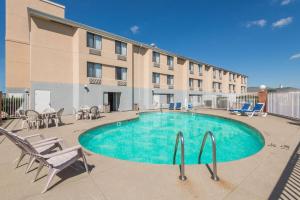 a swimming pool in front of a building at Super 8 by Wyndham Jasper in Jasper