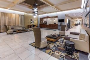 a large living room with couches and a tv at Wyndham Garden Greensboro in Greensboro