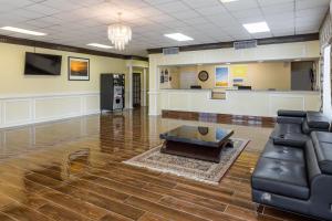 a living room with a couch and a coffee table at Days Inn by Wyndham Madison in Madison