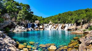 a pool of water in front of a waterfall at Casa Versini in Balogna