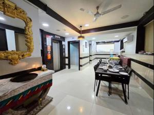 a dining room with a table and a mirror at The Platinum in Kolkata
