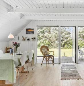 a kitchen and dining room with a table and chairs at 20135-Ulfborg-Fyrrebakken-7 in Ulfborg