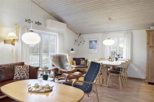 a living room with a table and chairs at 20723-Ulfborg-Sortebaervej-1 in Ulfborg