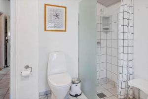 a white bathroom with a toilet and a sink at 20723-Ulfborg-Sortebaervej-1 in Ulfborg +17 photos