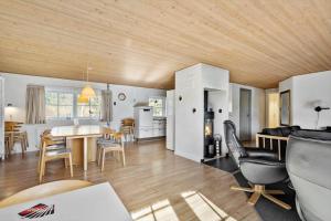 a kitchen and living room with a table and chairs at 51401-Ulfborg-Sdr-Fjandvej-46 in Ulfborg