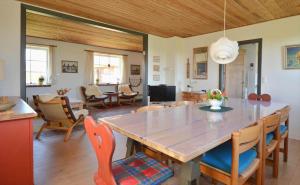 a dining room and living room with a table and chairs at 20202-Ulfborg-Husby-Klitvej-15 in Ulfborg