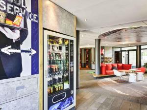 a lobby with a soda machine in a building at Ibis Orly Chevilly Tram 7 in Chevilly-Larue