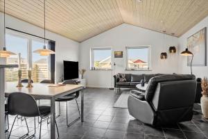 a living room with a table and chairs at 70751-Ulfborg-Fjordvaenget-13 in Ulfborg