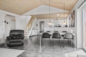 a kitchen and dining room with a table and chairs at 70751-Ulfborg-Fjordvaenget-13 in Ulfborg