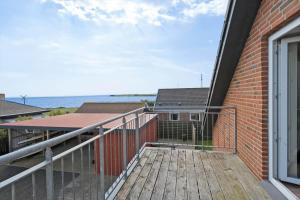 a balcony of a house with a view of the ocean at 70751-Ulfborg-Fjordvaenget-13 in Ulfborg