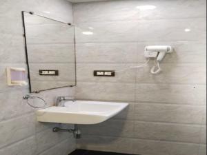 a bathroom with a sink and a mirror at The Platinum in Kolkata +27 photos