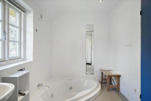 a white bathroom with a tub and a window at 20780-Ulfborg-Sundhuse-26 in Ulfborg +14 photos