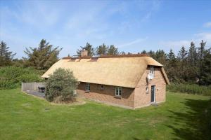 a small brick house with a roof on a field at 20780-Ulfborg-Sundhuse-26 in Ulfborg