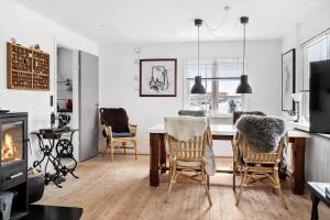 a living room with a table and chairs and a fireplace at 70268-Ulfborg-Vesterhavsgade-16 in Ulfborg