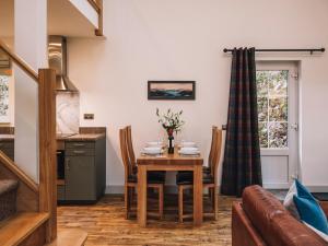 a kitchen and dining room with a table and chairs at An Dobhran - Ukc5752 in Dornie