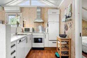 a kitchen with white cabinets and a white refrigerator at 30071-Ulfborg-Klovervej-479 in Ulfborg