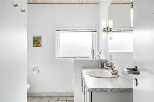 a white bathroom with a sink and a window at 30071-Ulfborg-Klovervej-479 in Ulfborg +18 photos