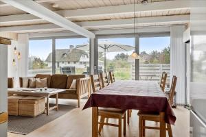 a dining room with a table and a couch at 20145-Ulfborg-Knakvej-16 in Ulfborg