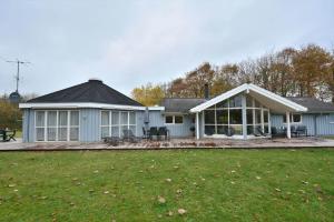 a blue house with a large yard in front of it at 80608-Vemb-Knudehus-51 in Vemb