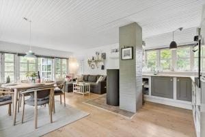 a kitchen and living room with a table and a dining room at 10173-Ulfborg-Gaffelbjergvej-24 in Ulfborg