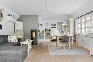 a living room with a couch and a table and a kitchen at 10173-Ulfborg-Gaffelbjergvej-24 in Ulfborg +14 photos