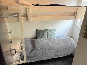 a bedroom with two bunk beds and a bed at 30826-Ulfborg-Klovervej-480 in Ulfborg