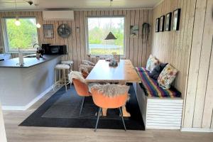 a kitchen and dining room with a table and chairs at 30826-Ulfborg-Klovervej-480 in Ulfborg