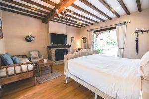 a bedroom with a large bed and a fireplace at Moon River Village in Ban Bu Khanun