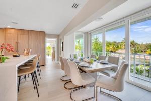 a kitchen and dining room with a table and chairs at Peninsula Villa Boat Dock Heated Pool Sunset Point in Islamorada