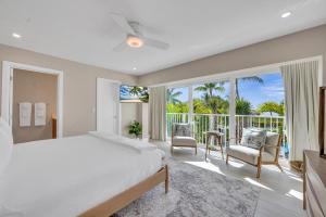 a bedroom with a large bed and a balcony at Peninsula Villa Boat Dock Heated Pool Sunset Point in Islamorada